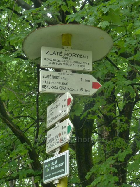 Turistický rozcestník Zlaté Hory (žst.) před nádražím ČD