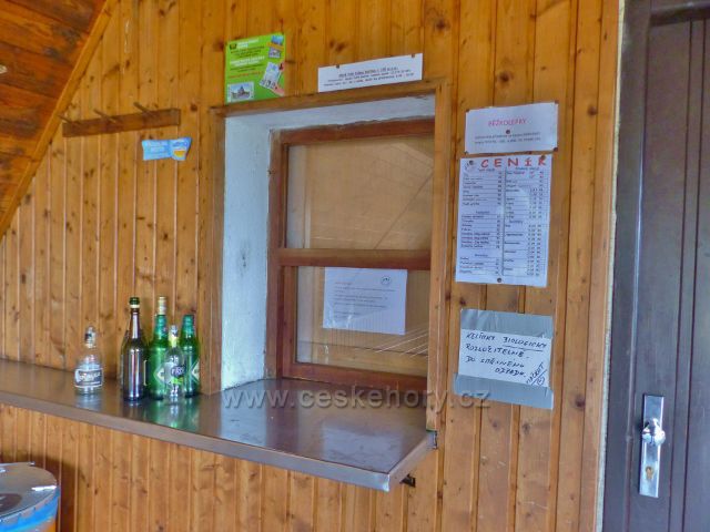Interiér srubu HS "Občerstvení" - tabulka na výdejním okénku objasňuje absenci obsluhy a návazně i návštěvníků - opatření protivirové karantény